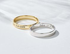 two wedding rings with names engraved on them