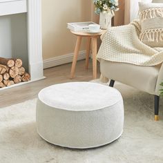 a living room scene with focus on the ottoman and footstool in the foreground