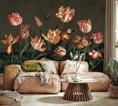 a living room with flowers painted on the wall and a couch in front of it