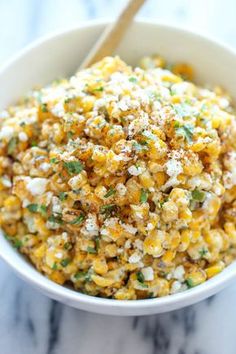 a white bowl filled with corn and cheese