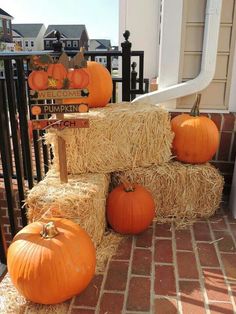 hay bales stacked on top of each other with pumpkins