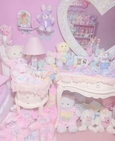 a room filled with lots of stuffed animals next to a dresser and mirror on the wall