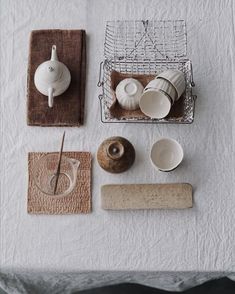 the table is covered with dishes and cups