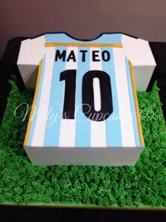 a cake made to look like a soccer jersey with grass on the bottom and sides