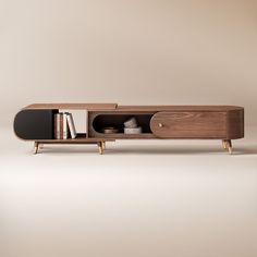 a wooden shelf with books and magazines on it in front of a beige wall,