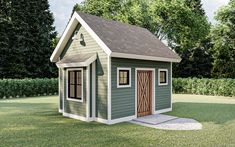 a small green shed sitting on top of a lush green field