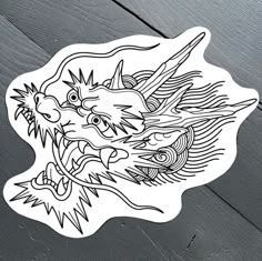 a sticker with an image of a dragon on it's face and head