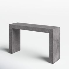 a concrete bench sitting on top of a white floor