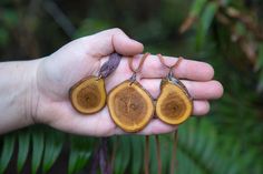 This simple design is a Terra Mana original, and was created out of a sliced/ sanded/ varnished piece of wood and features the beautiful, natural pattern of the wood. These necklaces are very light weight and hang mid to low chest on most. THIS LISTING IS FOR 1 WOOD SLICE NECKLACE.  Please refer to the photos and select your piece. Choice A of these 3 pieces is hung from a dark purple colored strand of sari silk however I am happy to hang it from leather instead upon request. Please make a clear note in your order indicating beige leather or brown leather if you opt for this. Choices B & C are hung from brown leather. I can swap out the purple sari silk for leather if you'd prefer, just indicate that when you purchase. The size of the wood slices vary slightly but are all between 1 and 2 i Wood Slice Necklace, Sari Silk Jewelry, Earth Jewelry, Magic Crafts, Jewelry Wood, Necklace Wood, Silk Jewelry, Wood Necklace, Wood Jewelry