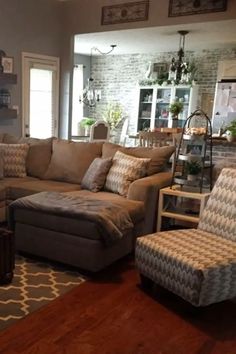 a living room filled with lots of furniture and decor on top of a hard wood floor