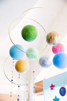 colorful balls hanging from the ceiling in a child's room