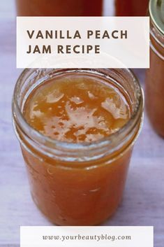 two jars filled with jam sitting on top of a wooden table