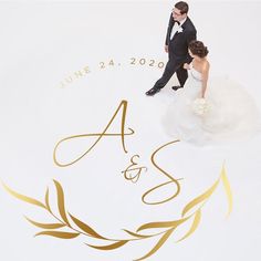 a bride and groom standing on top of a white floor next to each other with gold lettering