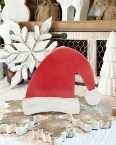 a wooden santa hat sitting on top of a table