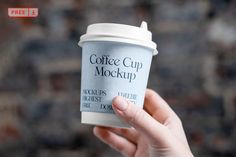 a hand holding up a coffee cup with the word coffee cup mockup on it