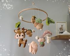 several stuffed animals are hanging from a wooden frame in a room decorated with snowflakes