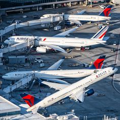 several airplanes are parked at an airport terminal