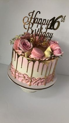 a birthday cake with pink frosting and roses