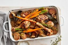 a casserole dish with chicken, carrots and mushrooms