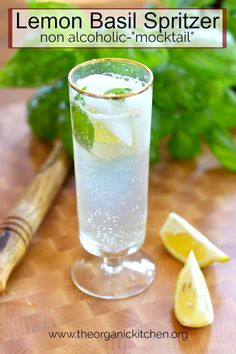 a lemon basil spritzer in a tall glass with ice