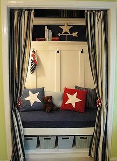 a room that has some curtains on the wall and a bed with stars in it