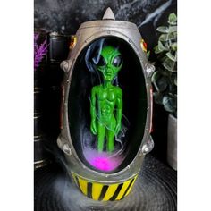 This alien in space craft capsule backflow incense burner is made of polyresin, hand painted and polished individually. This sculpture uses LR44 battery for its LED mechanism.  This alien with spaceship backflow incense burner measures 6.75" High, 3.75" Wide and 3.75" Deep approximately. It weighs about 1 pound.  Beep Beep Beep! Make way for this Roswell Alien pawn that has just landed on earth with his space ship capsule! When backflow incense cone is lit at the top of the spaceship, cascading Baby Boy Sip And See, Roswell Alien, Shark Week Party, Cone Incense Burner, Backflow Burner, Alien Halloween, Backflow Incense Burner, Cone Incense, Incense Burner Holder