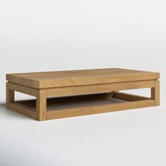 a wooden coffee table sitting on top of a white floor