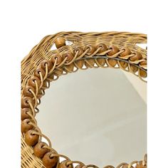 a wicker mirror with wooden beads on it