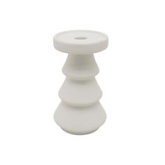 a small white candle holder on a white background with no one around it to see in the photo