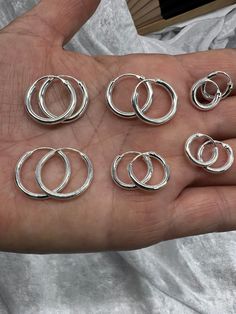 Round Silver Huggie Hoop Earrings / Circle Loop Earring Earrings/  Sleeper Hinged Hoop Earring / Hypoallergen / Gift For Her Material : 925 Sterling Silver Dimensions : Thickness :2 mm Size L Earring: 20 x 20 mm,  Weight: 1.50 gr Size M Earring: 14 X 14 mm,   Weight: 1.10 gr Size S Earring: 12 X 12 mm, Weight: 0.80 gr Thickness :2.5 mm Size L Earring: 18 X 18 mm,  Weight: 1.9 gr Size M Earring: 16 X 16 mm,  Weight: 1.7 gr Size S Earring: 12 X 12 mm,  Weight: 1.2 gr Earrings is packed in a organza pouch, so your item will make a perfect gift for someone you love. Polished solid silver. Keep it clean with a non-tarnishing clothes. WE CANNOT ACCEPT RETURNS FOR EARRINGS FOR HYGIENE REASONS! PLEASE MAKE SURE YOU HAVE SELECTED THE SIZE YOU REQUIRE BEFORE ORDERING. Thank you for supporting our sm Earrings Circle, Loop Earrings, Huggie Hoop Earrings, Jewelry Earrings Hoops, Star Earrings, Gift For Her, Etsy Earrings, Silver Bracelet, Silver Jewelry