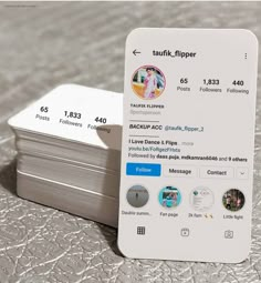 a white business card sitting on top of a table next to a silver metal object