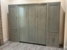 an empty room with two large gray cabinets