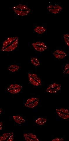 red glitter lip prints on a black background