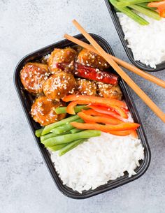 two black trays filled with rice and meat covered in sesame seeds next to chopsticks