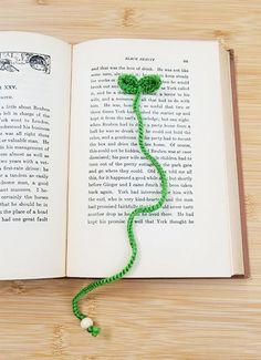 an open book with a green string attached to it