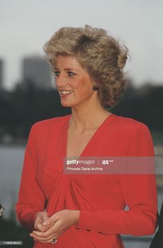 the princess of wales smiles as she stands in front of water