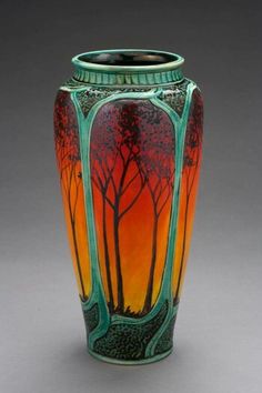 a vase with trees painted on it