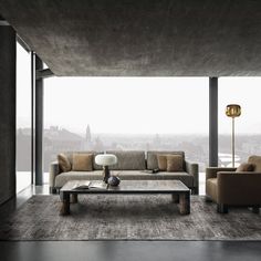 a living room filled with furniture and a large window over looking the cityscape