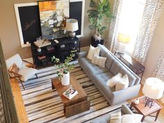 an overhead view of a living room with couches, chairs and tables in it