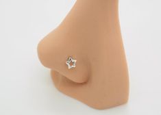 a small silver star stud on top of a mannequin's head