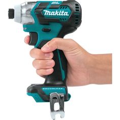 a hand holding a cordless drill in it's right hand, with the tool attached