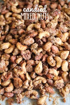 candied mixed nuts on a baking sheet with the words candied mixed nuts above it