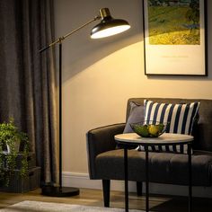 a living room scene with focus on the table lamp and chair next to the couch