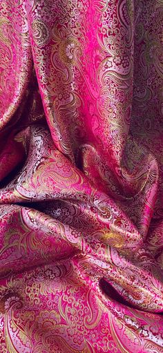 a pink and gold paisley print fabric