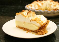 a piece of pie sitting on top of a white plate next to a pie pan