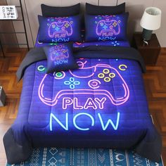 a bed with neon gaming themed comforters and pillows on it, along with the words play now