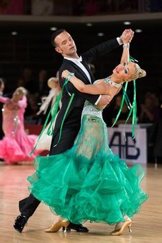 a man and woman dancing on a dance floor