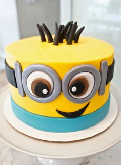 a yellow and blue cake decorated like a minion