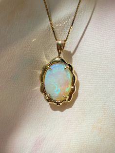 One of a kind incredible 4.84 ct. Australian Opal pendant, hugged by solid 14k yellow gold. Designed as a guardian from the etheric heavens above, imparting you with Divine protection, sacred wisdom and lending hope through universal love. Pendant is secured on an 18” 14k yellow gold box chain. Opal enhances cosmic consciousness and imparts mystical visions. Acting as a mirror, it reflects your thoughts and feelings back to you while shielding you as a karmic protector to deflect empathic emotio Stone Necklace Pendant, One Of A Kind Jewelry, Opal Aesthetic, Opal Accessories, Pendant Jewelry Design, Opal Jewelry Necklace, Cosmic Jewelry, Australian Opal Pendant, Opal Solitaire Ring