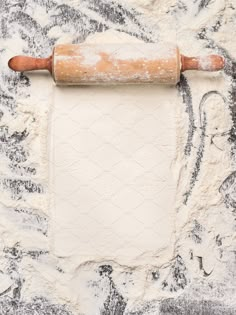 an old rolling pin on top of flour stock photo